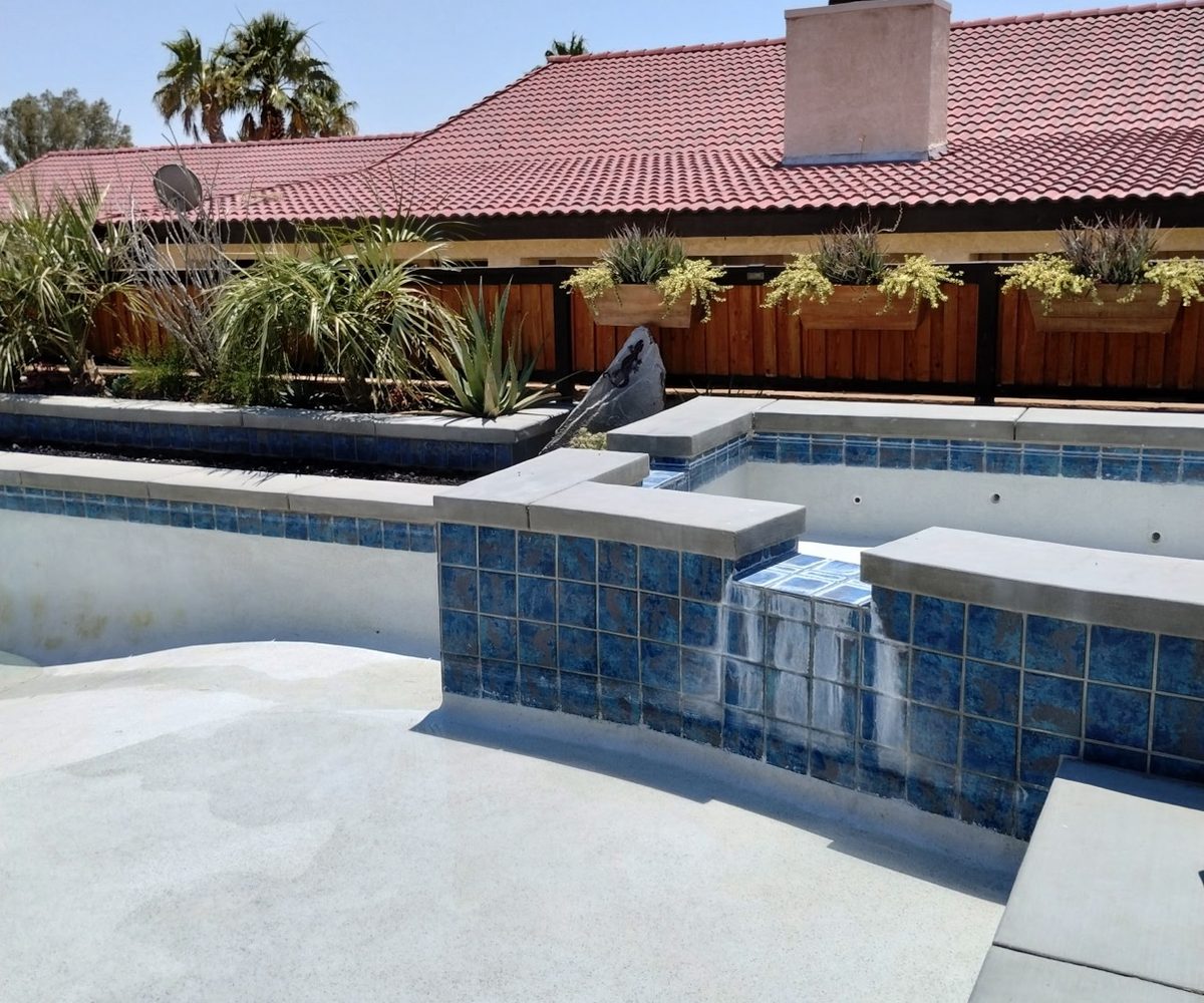 Spa and pool remodel with fresh blue tile and desert landscaping by Aqua Fresh Pool Service in the Coachella Valley