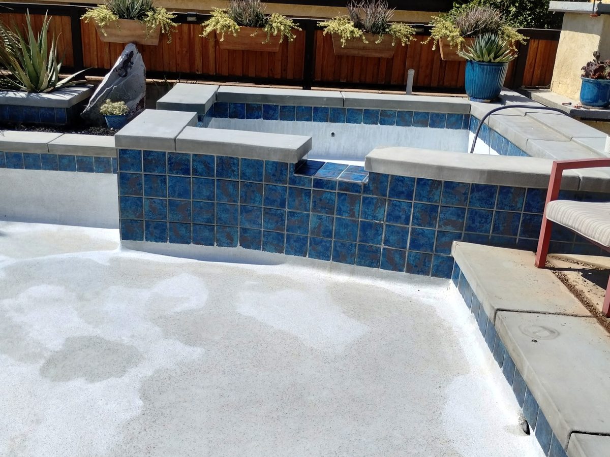 Blue-tile spa and raised wall on a Palm Springs pool remodel by Aqua Fresh Pool Service